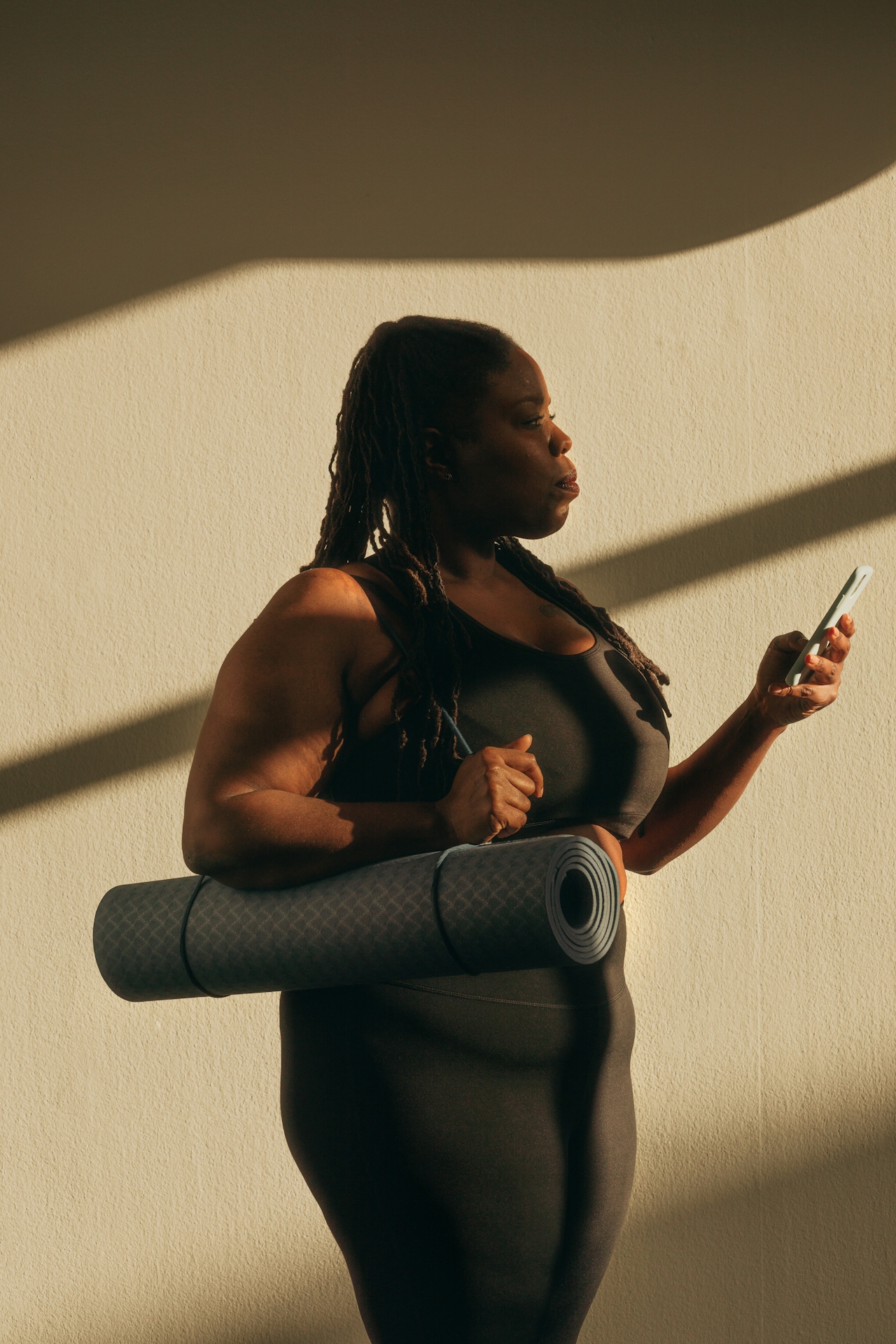 Heading to a workout with a yoga mat